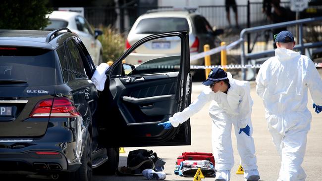 Forensic police examine Mick Hawi’s bullet-riddle car.  Picture: Toby Zerna