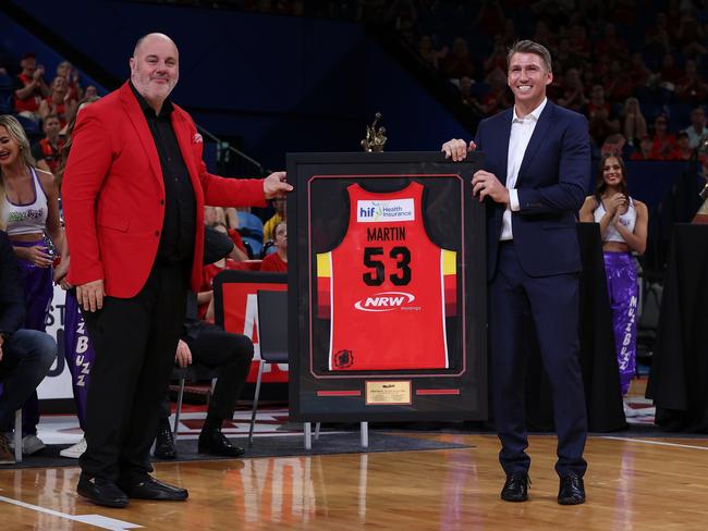 Craig Hutchison, pictured presenting former Wildcats captain Damian Martin a framed jersey during his jersey retirement ceremony, has reportedly shown interest in adding a second WNBL club to his sporting empire. Picture: Getty Images