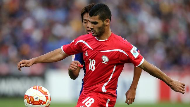 Musab Battat of Palestine controls the ball during the Asian Cup match against Japan.