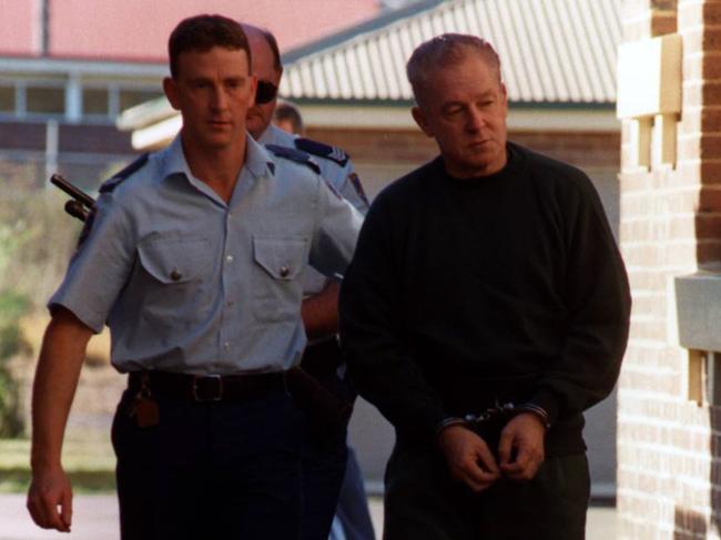 John Killick is escorted to court to face armed robbery charges in May 1999. Picture: Tracee Lea