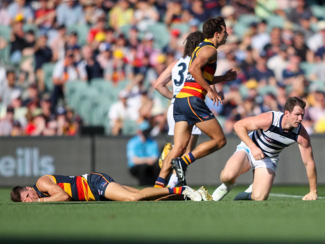 Jake Kelly came off second-best in this clash with Patrick Dangerfield.