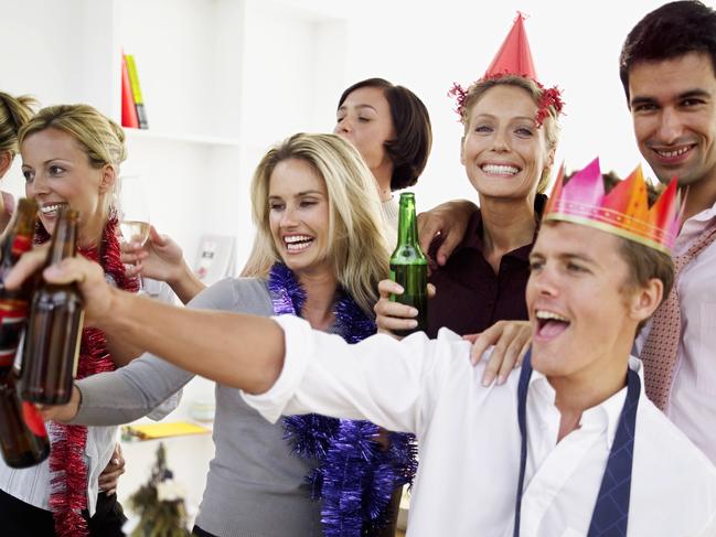 Close-up of co-workers celebrating with beers at a office Christmas party. Generic image. Thinkstock.