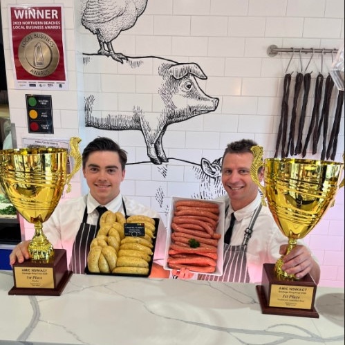 Millin's Free Range Butcher owner Stef Millin (right) with his trophies – and the winning sausages.