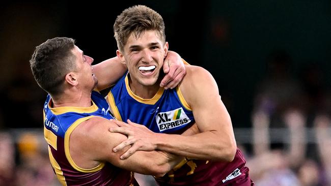 Dayne Zorko and Zac Bailey celebrate after a late goal saw off Carlton’s comeback. Picture: Bradley Kanaris/Getty Images