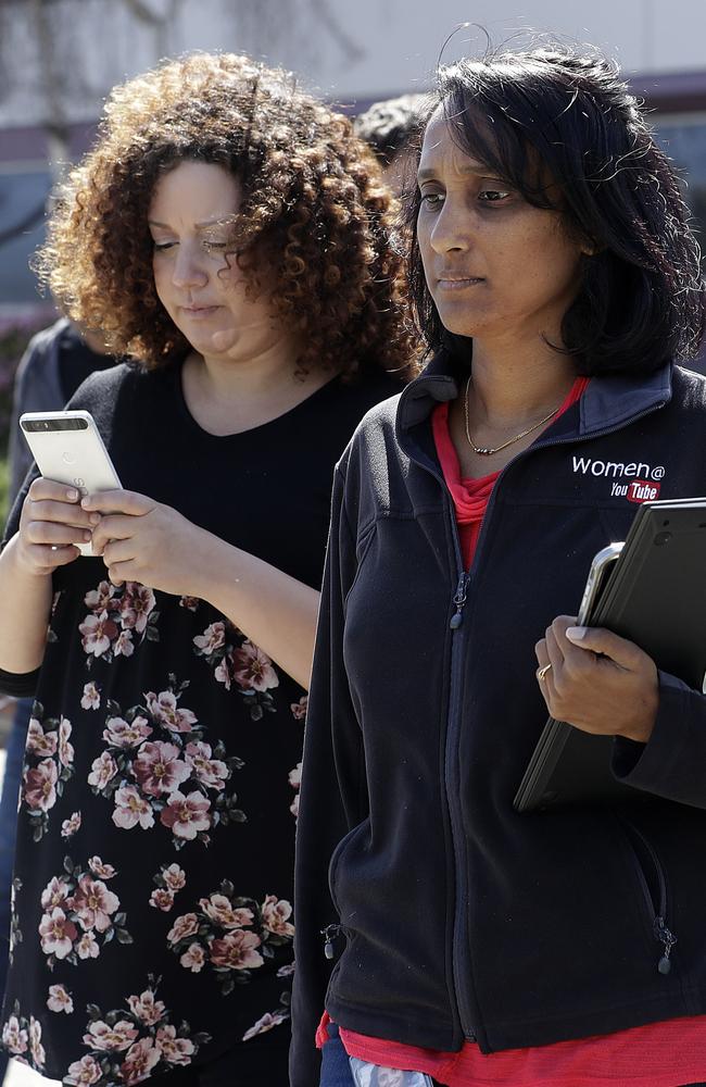 Workers walk down a street near YouTube offices in San Bruno, California, after a woman opened fire at the headquarters, setting off a panic among employees and wounding several people before fatally shooting herself. Picture: AP