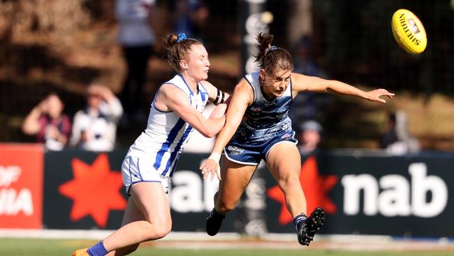 Madeline Keryk gets a kick away in the nick of time for Geelong.