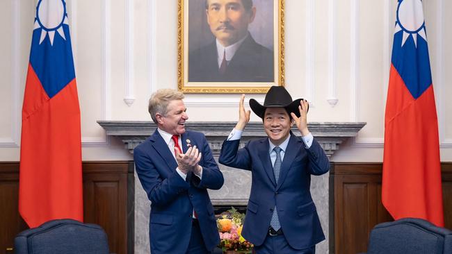 Taiwan's President Lai Ching-te puts on a hat received from US Representative Michael McCaul during a meeting at the Presidential Office in Taipei. Picture: AFP