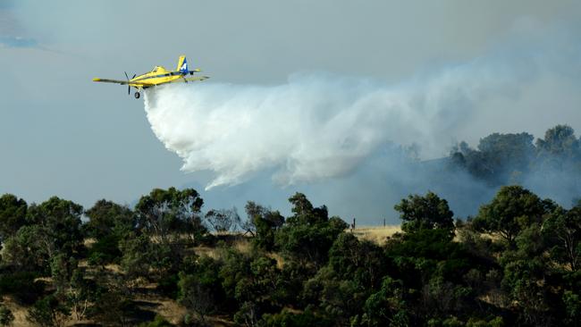 A water bomber fights flames from above in this file picture. Photo: Mark Brake.