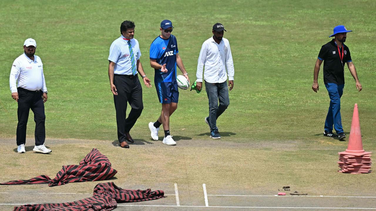 Umpire Javagal Srinath (2nd from left) and New Zealand captain Tim Southee (3rd from left) inspect the pitch before the start of the one-off cricket test match between Afghanistan and New Zealand at the Shaheed Vijay Singh Pathik Sports Complex in Greater Noida on September 10, 2024. The one-off test between Afghanistan and New Zealand near New Delhi was postponed again on September 10 as the coin toss has not yet taken place following overnight rain. (Photo by Money SHARMA / AFP)