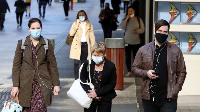 People wearing masks in the Brisbane CBD after they were made mandatory from 1am Tuesday. Picture: Liam Kidston