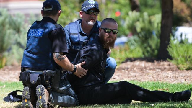 ADELAIDE, AUSTRALIA - JANUARY 26: Member of the National Socialist Network (NSN) is being arrested during a counter protest on North Terrace and East Terrace on January 26, 2025 in Adelaide, Australia. Australia Day, formerly known as Foundation Day, is the official national day of Australia and is celebrated annually on January 26 to commemorate the arrival of the First Fleet to Sydney in 1788. Many indigenous Australians refer to the day as 'Invasion Day' and there is a small but growing movement to change the date amid broader debate on the day's significance. (Photo by Tracey Nearmy/Getty Images)