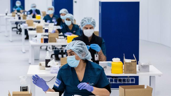 Medical staff prepare vaccines in the pharmacy area of the NSW Vaccination Centre in Homebush, Sydney. Picture: James Gourley