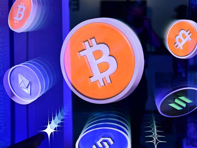 Logos of Bitcoin and different cryptocurrencies are displayed during the Token2049 conference at  the Token2049 conference in Dubai on May 1, 2025. (Photo by Giuseppe CACACE / AFP)