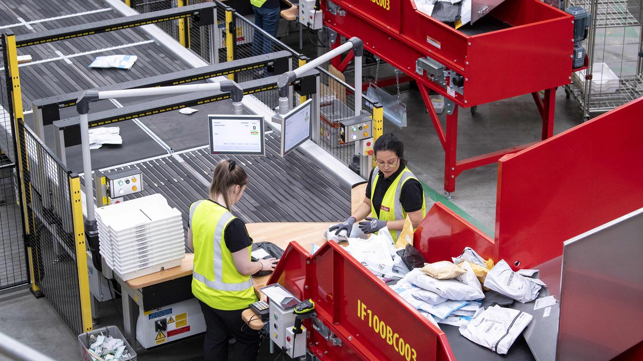 Parcel officers inducting parcels in the small parcel area of new facility at Adelaide Airport. Picture: Mark Brake