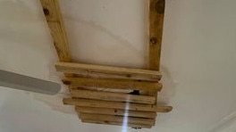 Makeshift timber supports a water damaged ceiling.