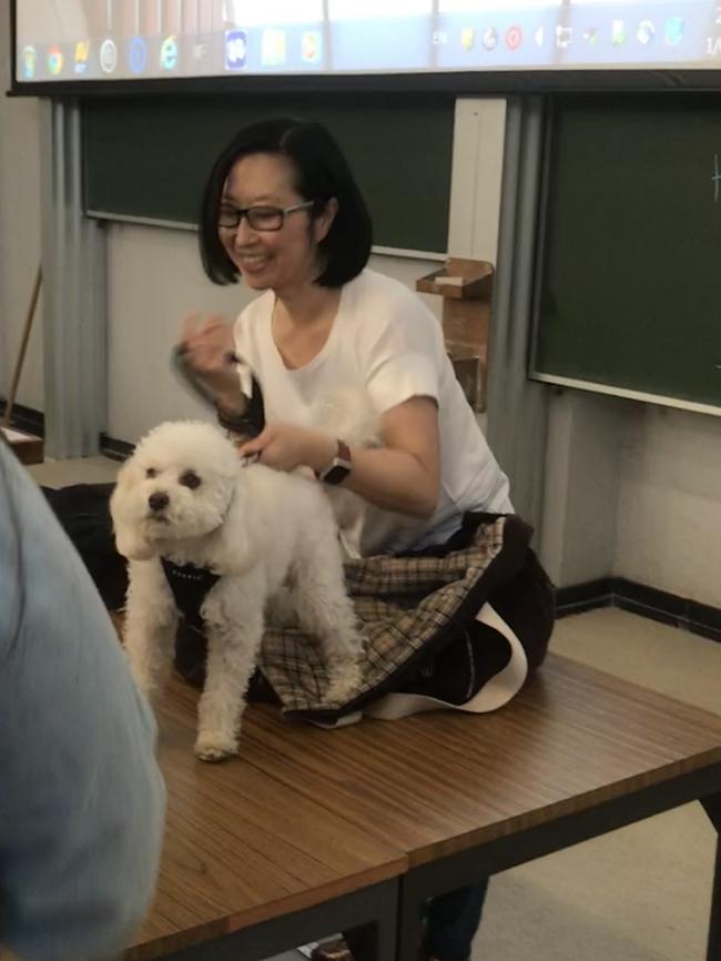 University of Sydney lecturer Professor Jane Park with her dog as a student approaches to pat it. (Pic: Supplied)