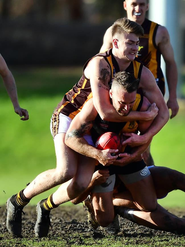 A different type of hug in the Modbury v Broadview match as Hawk Lynch Jackson gets Tiger Adrian Stephens high on Saturday. Picture: AAP/Mark Brake