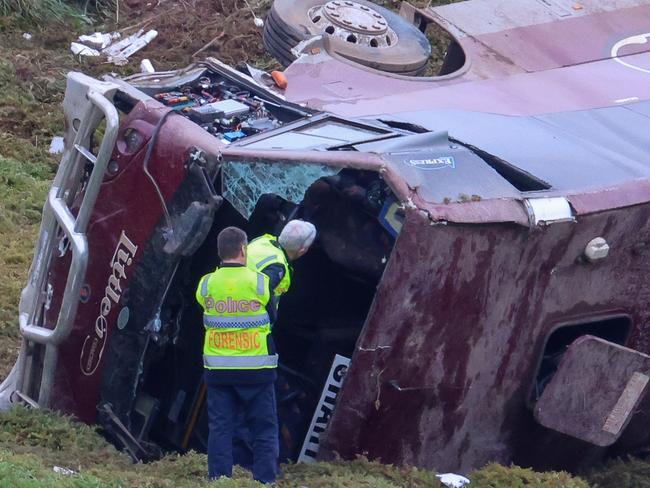 MELBOURNE, AUSTRALIA- SEPTEMBER 21 A school bus carrying 32 people has flipped on the Western Highway in Bacchus Marsh. Police are investigating the crash between a school bus and a truck that occured at around 3.15am. Picture: Brendan Beckett