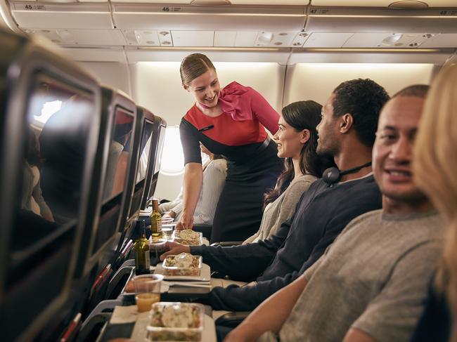 From Jan 20, Qantas will be offering direct seasonal flights from Sydney to Sapporo’s New Chitose Airport, to help make it easier for travellers to reach Hokkaido’s world-class ski resorts on Japan's northernmost island. Picture: Supplied/Qantas.    Inflight economy cabin passengers are getting food served in Qantas A330