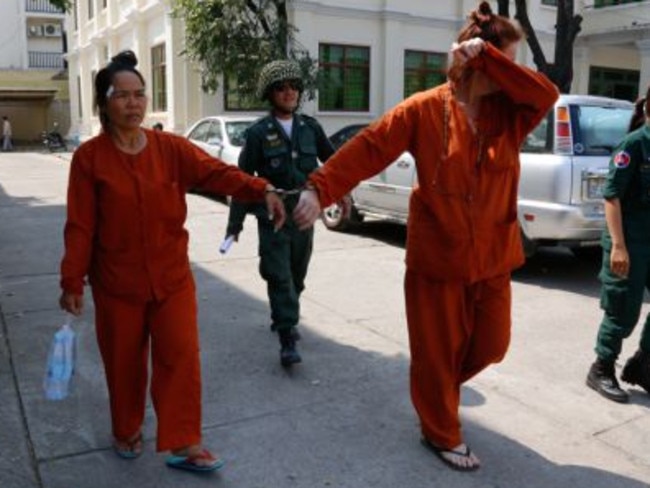 Australian Tammy Davis-Charles, (right) handcuffed in Phnom Penh to co-accused Samrith Chakriya has been jailed in shock decision over surrogacy racket. Picture: Heng Chivoan.