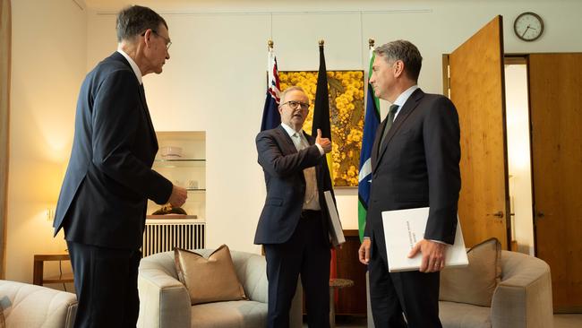 Former defence chief Angus Houston, left, delivers the defence review to Anthony Albanese, centre, and Richard Marles. Picture: Gary Ramage