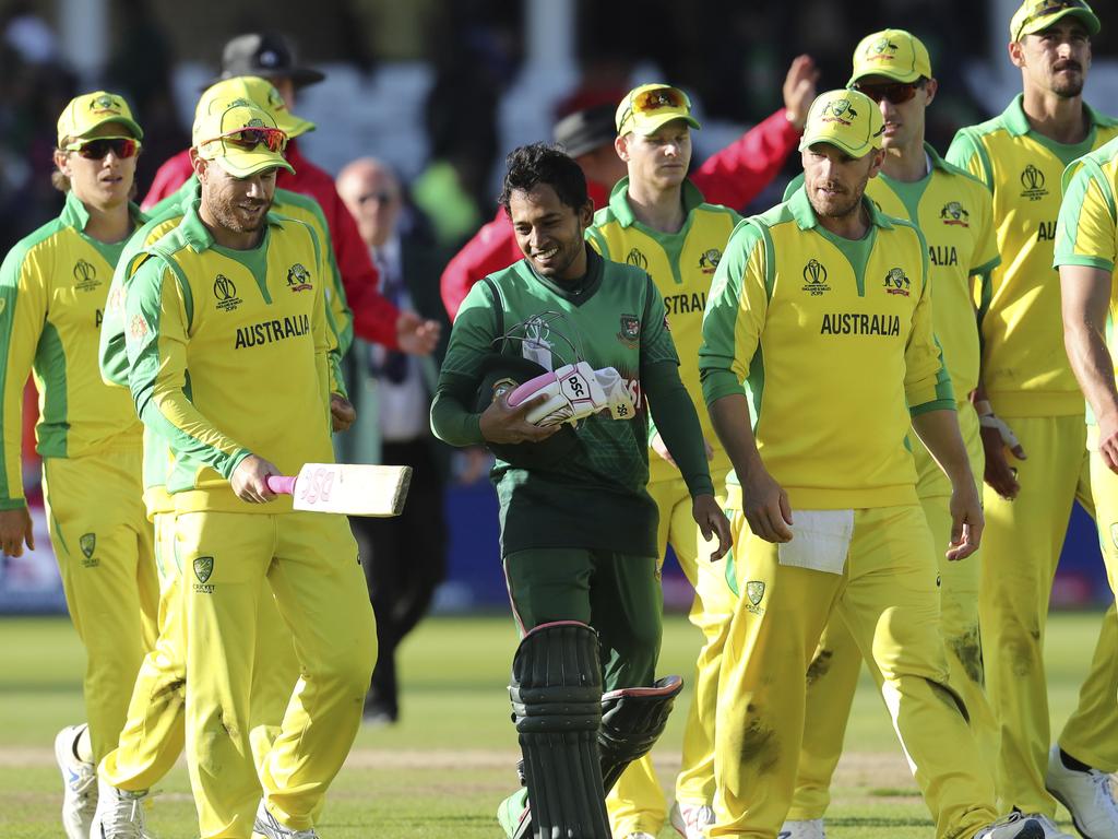 Australia's David Warner, second left, checks the bat of Bangladesh's Mushfiqur Rahim, in green jersey, after their win in the Cricket World Cup match between Australia and Bangladesh at Trent Bridge in Nottingham, Thursday, June 20, 2019. (AP Photo/Rui Vieira)