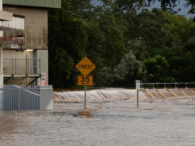 Floodwater gong over the levee wall in Molesworth Street, Lismore.