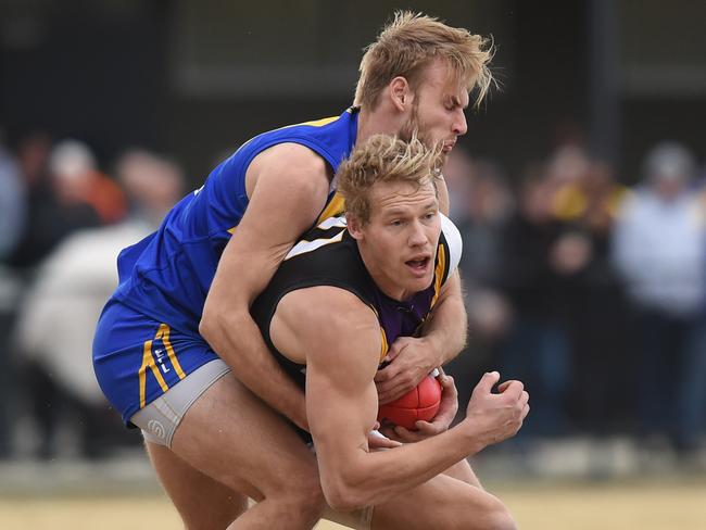 Matt Homfray lays a tackle on Norwood champion Leigh Williams. Picture: Chris Eastman