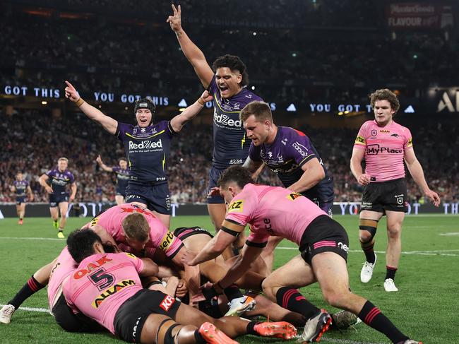 SYDNEY, AUSTRALIA - OCTOBER 06:  Jack Howarth of the Storm is help up over the try-line during the 2024 NRL Grand Final match between the Melbourne Storm and the Penrith Panthers at Accor Stadium on October 06, 2024, in Sydney, Australia. (Photo by Cameron Spencer/Getty Images)