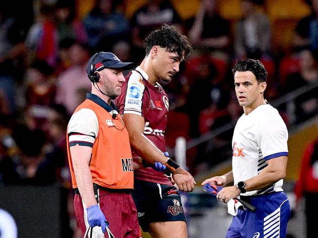 Reds star Jordan Petaia leaves the field after injuring his shoulder against the Highlanders. Picture: Bradley Kanaris/Getty Images