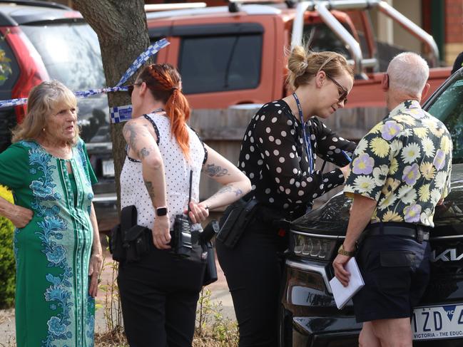 Police speak to locals after the incident. Picture: Brendan Beckett