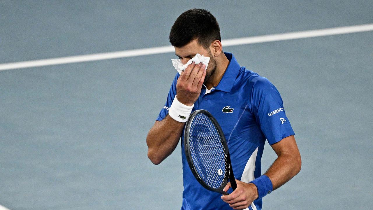 Serbia's Novak Djokovic blows his nose while playing against Alexei Popyrin. Picture: AFP