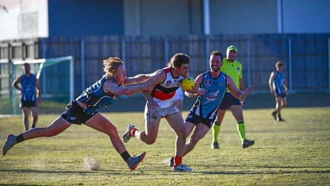 NOT GOING ANYWEHRE: Bay Power midfielder Marcus Dyson tries to tackle Bulldogs' fast-moving Joel Saunders. Picture: Brian Cassidy