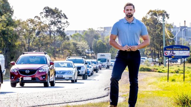 Division One Gold Coast City Council candidate Mark Hammel on the busy Eastern Service Road at Ormeau.