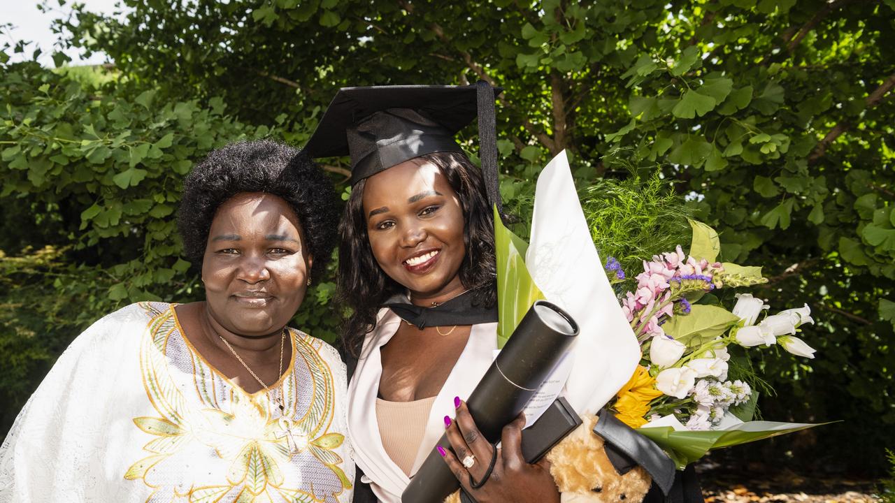 Bachelor of Commerce and Bachelor of Business graduate Mary Ngor celebrates with mum Sarah Duot at the UniSQ graduation ceremony at Empire Theatres, Tuesday, December 13, 2022. Picture: Kevin Farmer