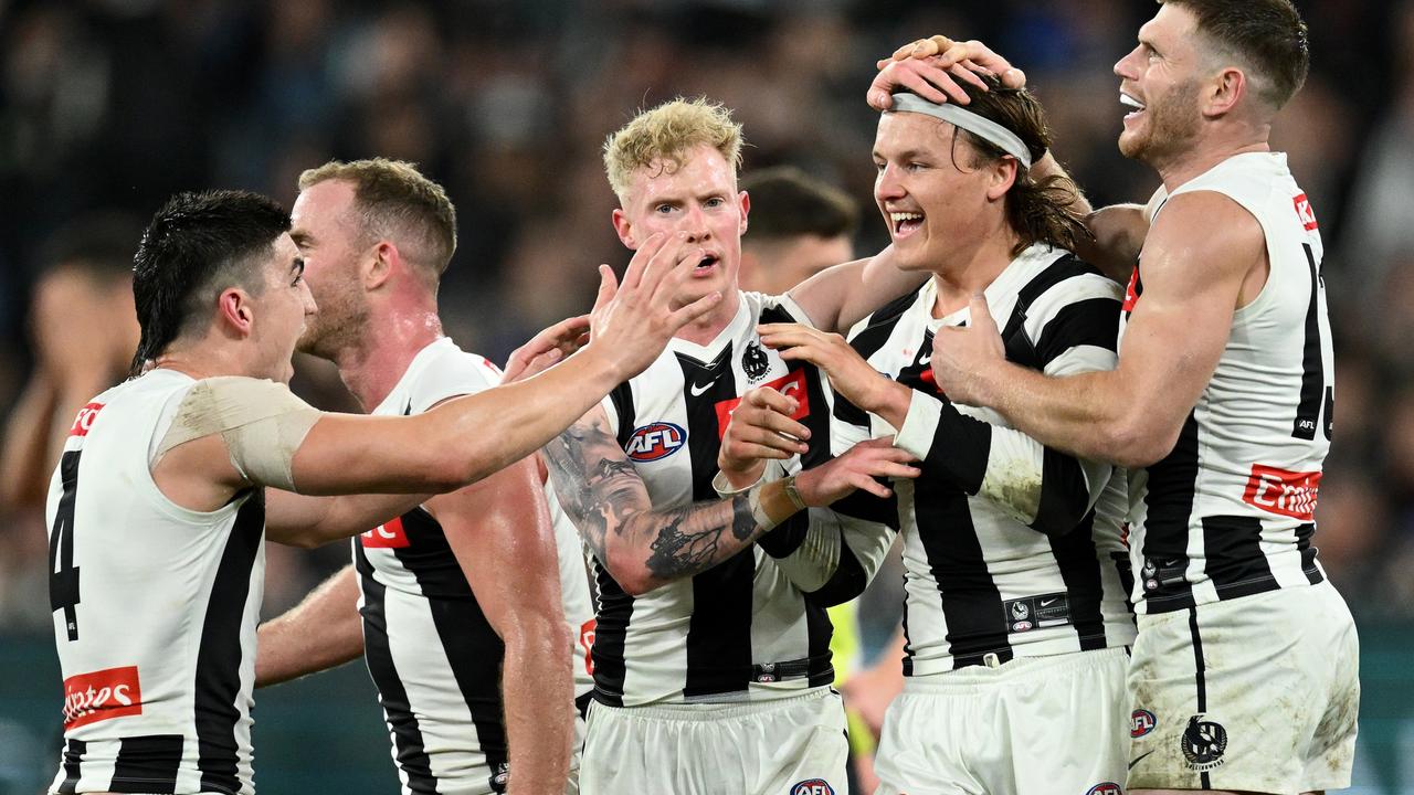 Jack Ginnivan is mobbed by teammates. Picture: Quinn Rooney/Getty Images