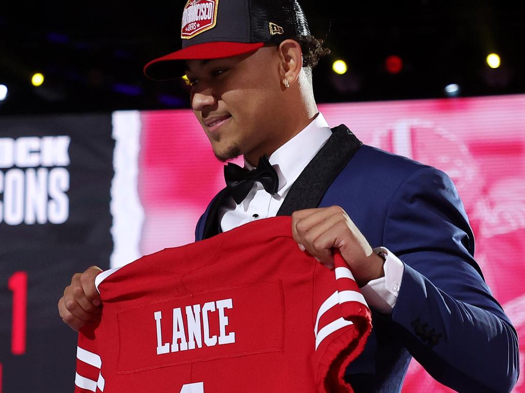 Trey Lance poses with a jersey onstage after being selected third by the San Francisco 49ers.