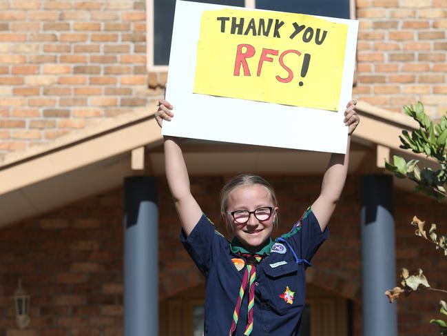 Bronte Mahaffrey, 12, made this sign to thank firefighters for a great effort in her under siege neighbourhood. Picture: Peter Lorimer