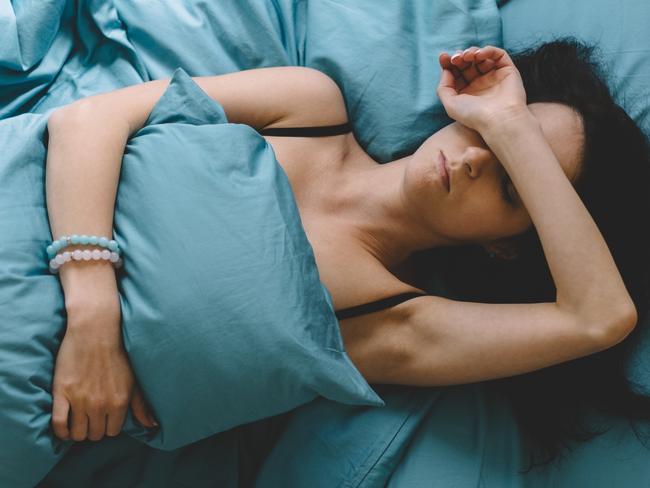 Depressed woman in bed with hand on forehead  Picture: istock