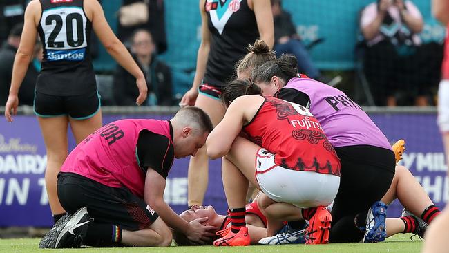 Lily-Rose Williamson in the hands of medical staff before being taken from the oval in the final minutes. Picture: Sarah Reed/AFL Photos via Getty Images