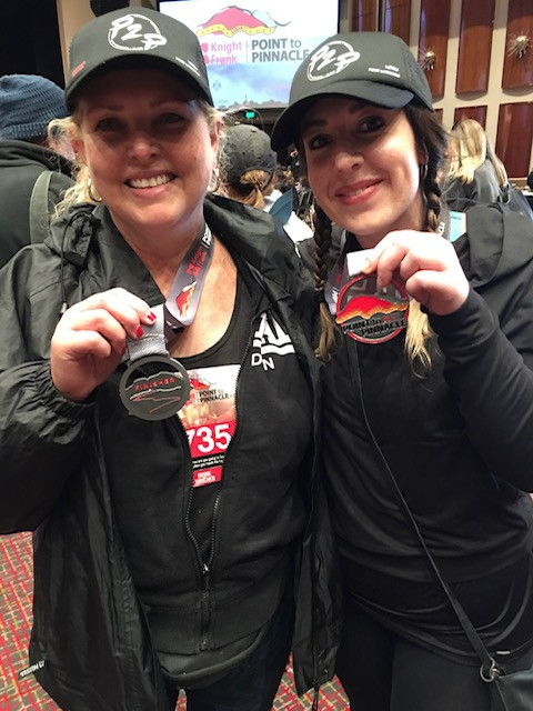 Kendra Magnussen, of Bellerive, and Hannah Andrews, of Claremont, compare medals after the event.