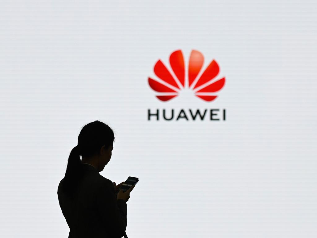 (FILES) This file photo taken on March 6, 2019 shows a staff member of Huawei using her mobile phone at the Huawei Digital Transformation Showcase in Shenzhen, China's Guangdong province. - The US administration on August 17, 2020 expanded its sanctions on China's Huawei, a move aimed at further limiting the tech giant's access to computer chips and other technology. A Commerce Department statement added 38 Huawei affiliates around the world to the "entity list," claiming that the company was using international subsidiaries to circumvent the sanctions which prevent export of US-based technology. (Photo by WANG ZHAO / AFP)