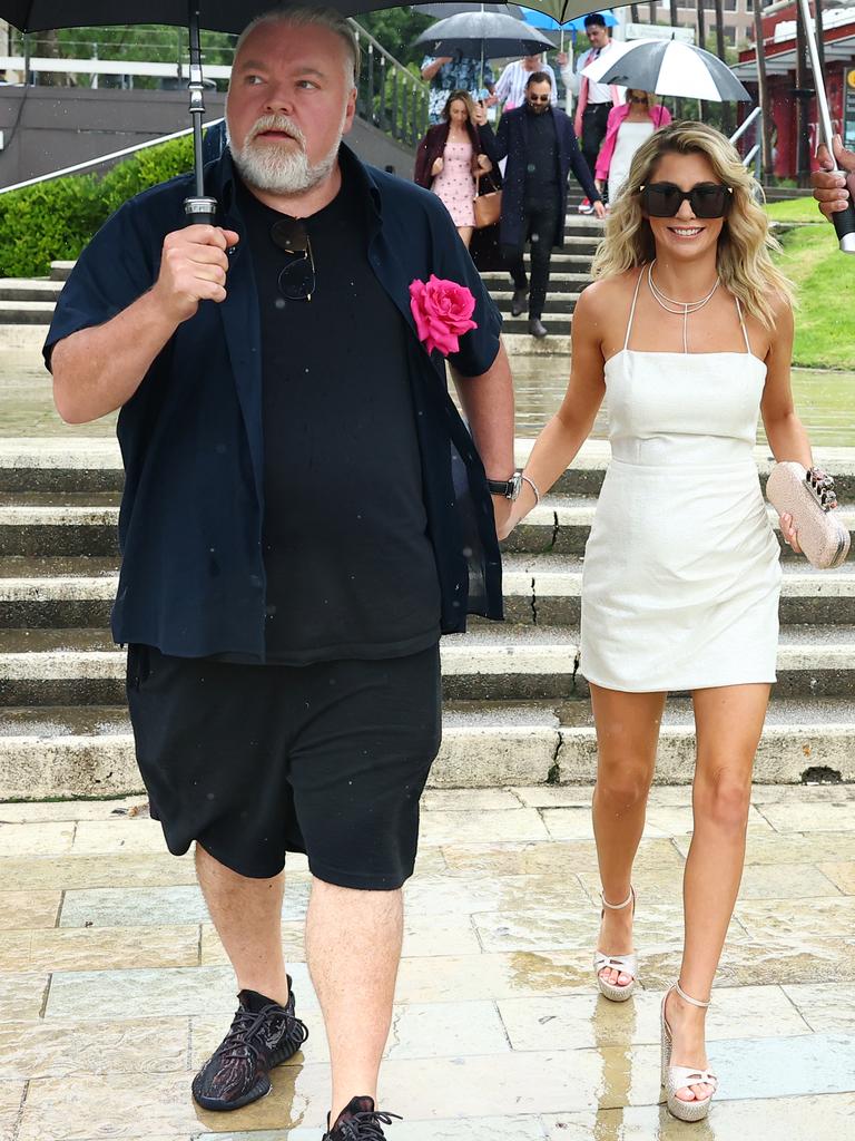 The pair walked through the rain on their way to the vessel. Picture: Matrix Media Group