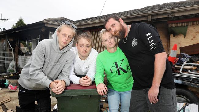 Melanie Menzies with her sons Reece and Jacob Hutchinson and partner Corey Hanson at what remains of their home. Picture: Alan Barber