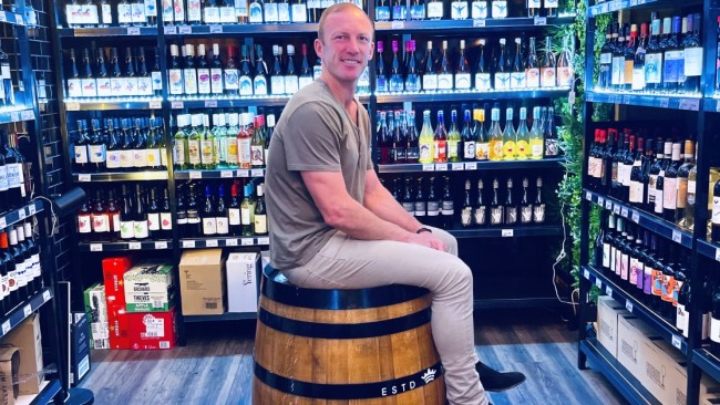 League legend Darren Lockyer in his South Brisbane bottle shop and gin bar.  He’s just distilled a rhubarb gin in his Eleven Bridges series. Photo: Des Houghton.