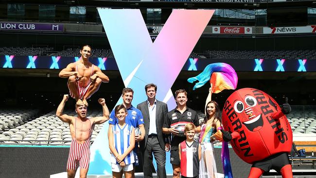 Shaun Atleyand Jack Billings pose with AFL CEO Gillon McLachlan during the AFLX Season Launch at Etihad Stadium.