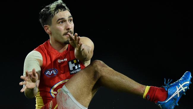 GOLD COAST, AUSTRALIA - AUGUST 12: Izak Rankine of the Suns kicks during the round 11 AFL match between the Gold Coast Suns and the Essendon Bombers at Metricon Stadium on August 12, 2020 in Gold Coast, Australia. (Photo by Matt Roberts/AFL Photos/via Getty Images)