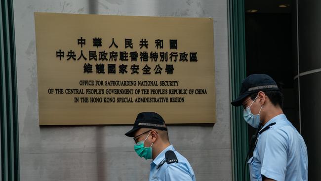 Police officers outside Hong Kong’s Office for Safeguarding National Security, which will guide enforcement of new national security laws. Picture: Getty Images)