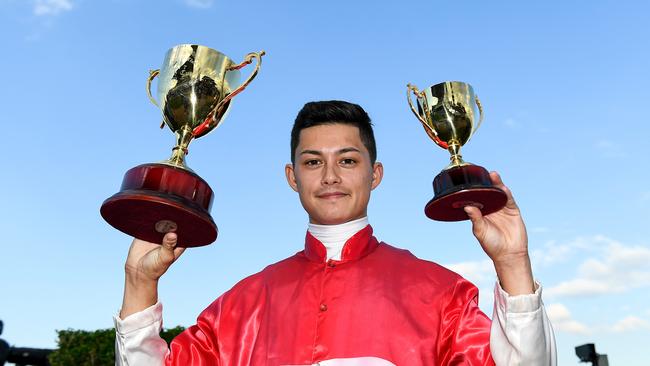 Jockey Michael Murphy poses with the trophy after riding Bergerac to victory in race 7, the Ipswich Cup, during the Ipswich Cup races at Ipswich, Saturday, June 15, 2019. (AAP Image/Albert Perez) NO ARCHIVING, EDITORIAL USE ONLY