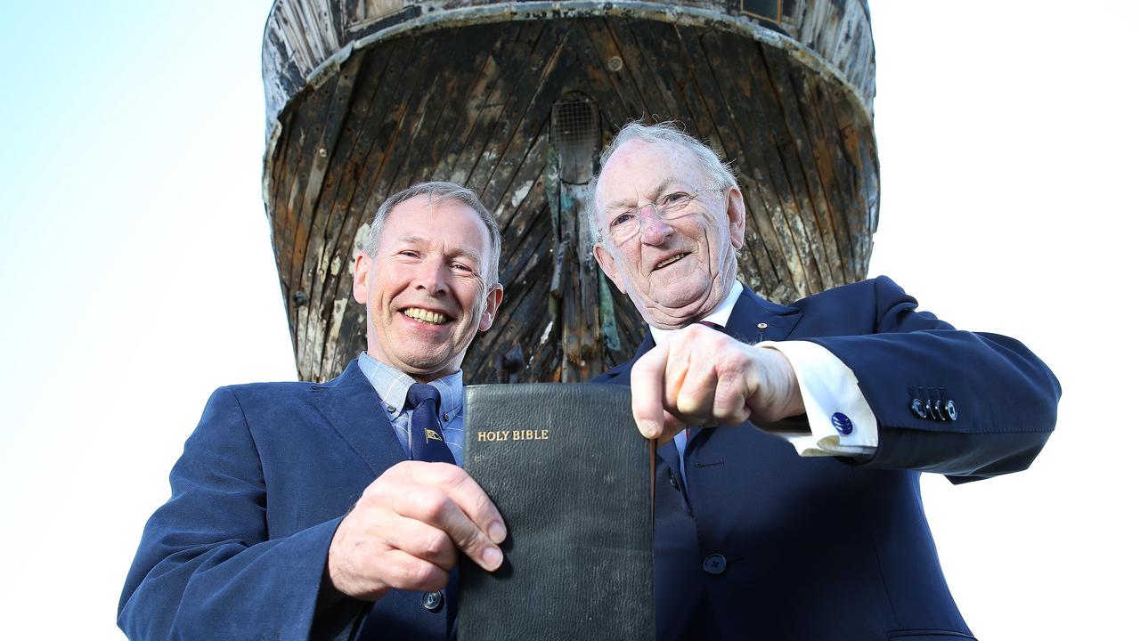 David Brown from Langbank, Scotland (Clyde Cruising Club) and Creagh O'Connor of North Adelaide (Chairman, Clipper Ship City of Adelaide Limited) in 2015 with the bible from the City of Adelaide clipper ship, which was handed over to volunteers who were looking after the historic ship at Port Adelaide. Picture: Stephen Laffer